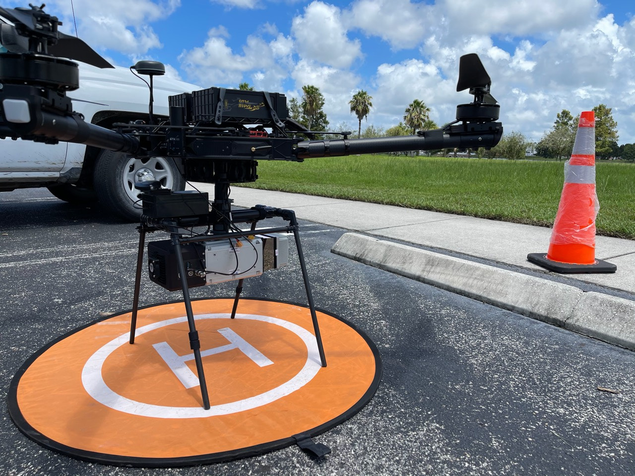 Freefly Alta X with a LiDAR payload on an orange landing pad