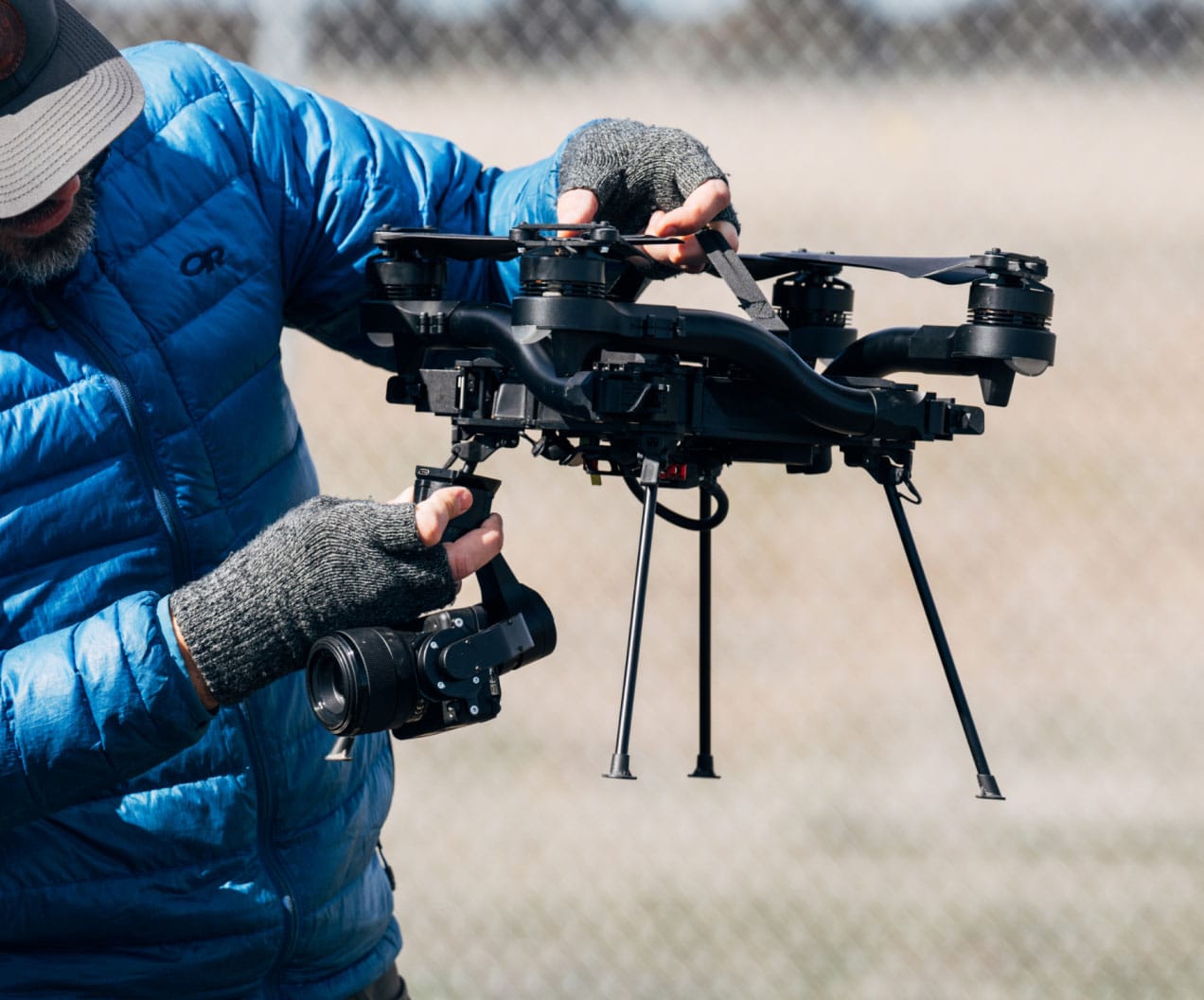 Operator changing the Sony camera and gimbal on a Freefly Astro in the field