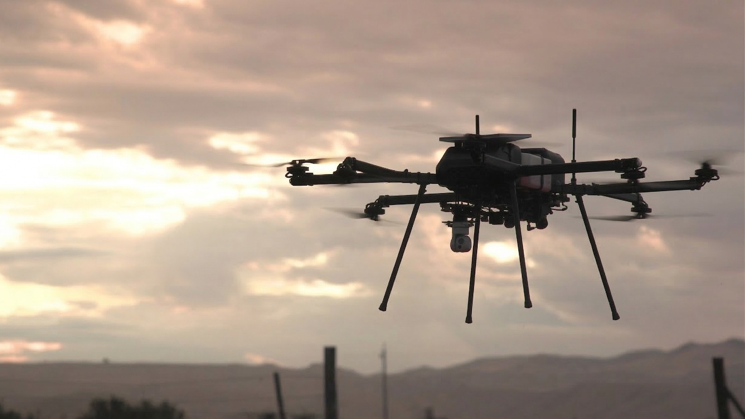 Skyfront Perimeter 8 with a camera gimbal and communications equipment flying at sunset