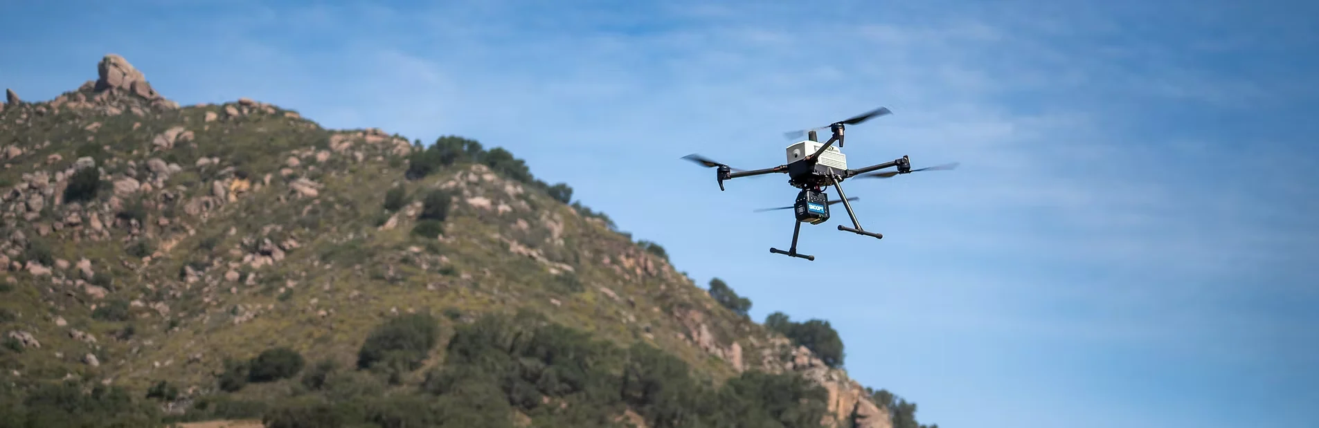 Snoopy ACE III flying over mountainous terrain
