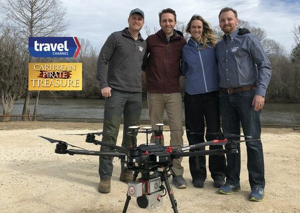 LiDARUSA with Philippe and Ashlan Cousteau beside a Surveyor-equipped UAV for Caribbean Pirate Treasure